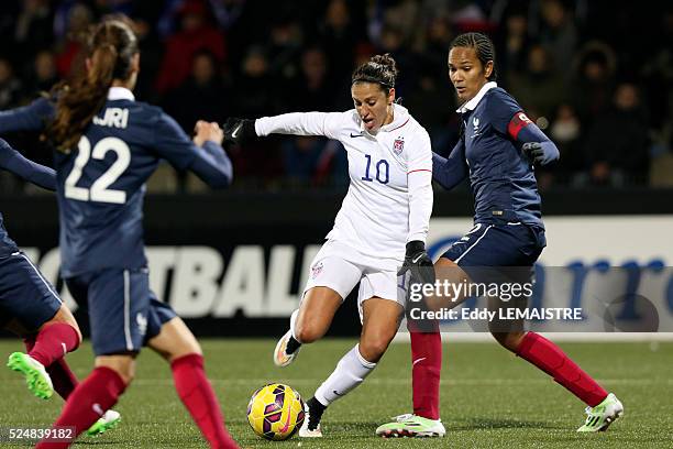 Carli Lloyd and Wendie Renard in action during an international women friendly football match France vs USA on February 8 at the Moustoir stadium in...