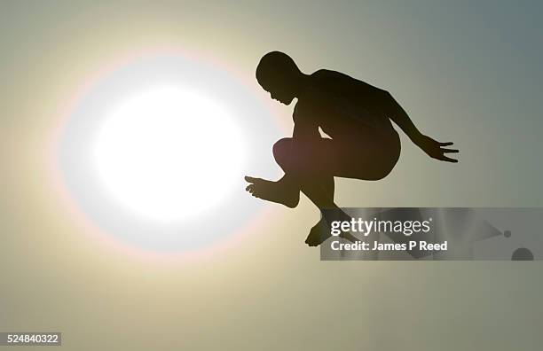 Young man launches from a diving board at a public swimming pool in Wichita, Kansas on July 18, 2006. The temperature in Wichita on Tuesday soared to...