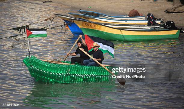 Young Palestinians on their boat made from remnants of empty plastic bottles inside the port of Gaza City