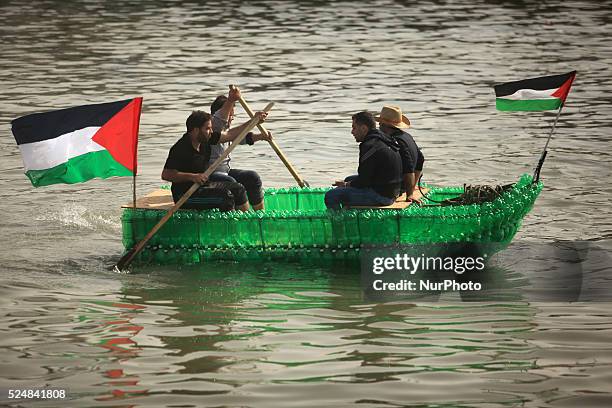 Young Palestinians on their boat made from remnants of empty plastic bottles inside the port of Gaza City