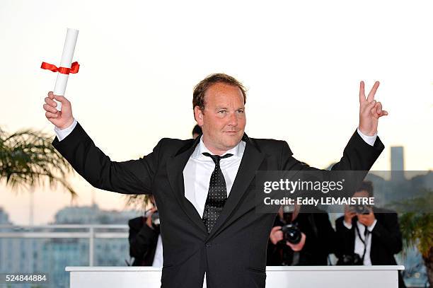 Xavier Beauvois with his Grand Prix award at the photo call for "The Palme d'Or Award Ceremony? during the 63rd Cannes International Film Festival.