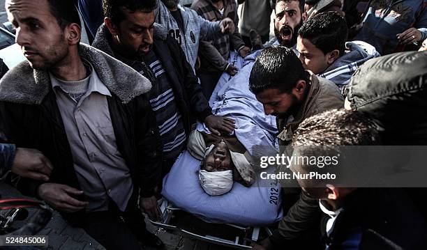 Palestinian medics wheel the body of Ibrahim Suleiman Mansour dead by Israeli security forces at a hospital in Gaza City on February 13, 2014. A...