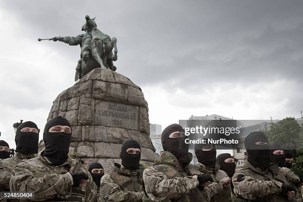 Combatants of Ukrainian Azov battalion pray near Bohdan Khmelnytsky monument before they were sent on a theater of ATO.