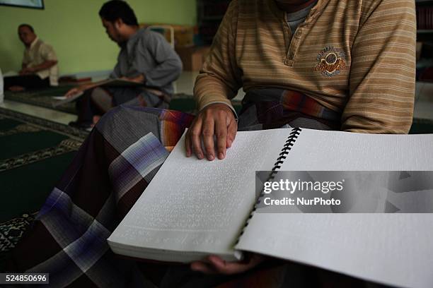 June 24 : Blind men reads a Braille Quran at Raudlatul Makfufin Foundation in Tangerang, outskrit of Jakarta, Indonesia, on June 24, 2015. Braille...