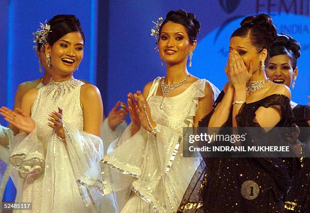 Contestants applaud Winner of the Pond's Femina Miss India 2005 Universe Amrita Thapar as she reacts on hearing her name as the winner during the...