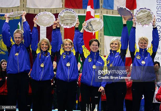 The Swedish curling team of Anna Bergstroem, Ulrika Bergman, Catherine Lindahl, Eva Lund and Anette Norberg pose with their trophy after winning the...