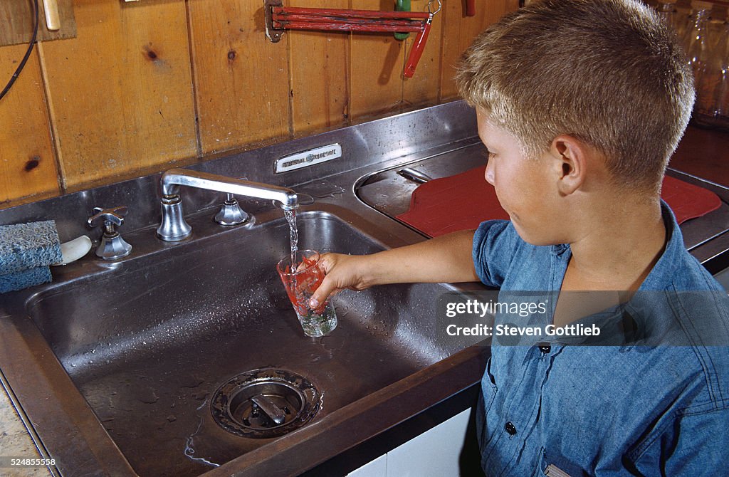 Boy Getting Glass of Tap Water