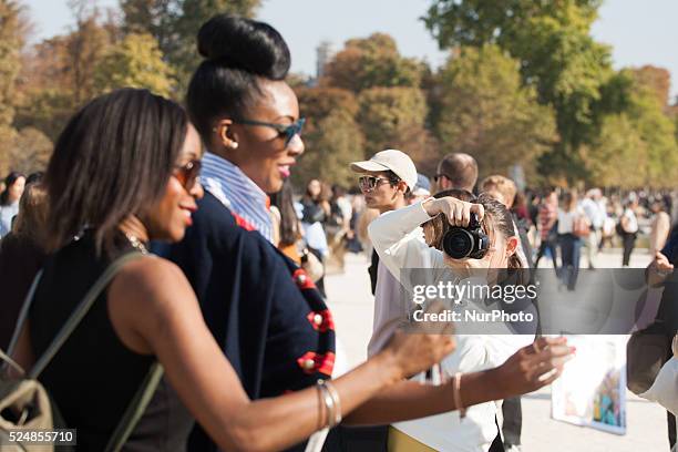 Models, photographers and fashion professionals are seen gathering outside the shows during Paris Fashion Week. Formal shows take place on the runway...