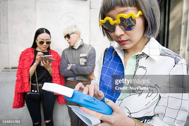 Invitees wait outside ahead of Chinese designer Masha Ma's show at the Monica Bismarck American Center on 4th October 2015. Outside less established...