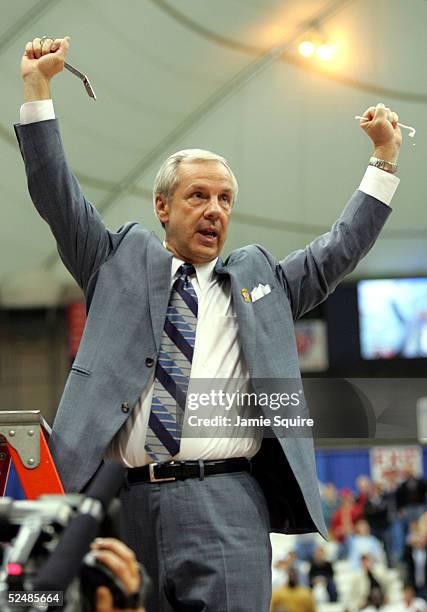 Head coach Roy Williams of the North Carolina Tar Heels cuts down the net after their victory over the Wisconsin Badgers in the regional semi-final...