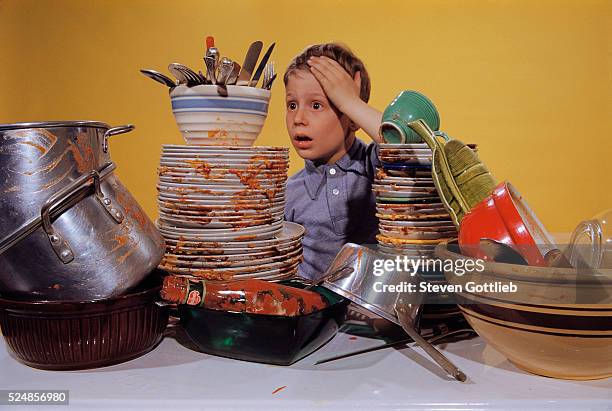 Boy Overwhelmed by Dirty Dishes