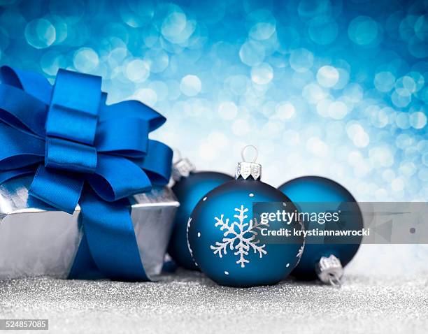 three blue bauble and silver christmas gift on glitter - blue baubles stock pictures, royalty-free photos & images