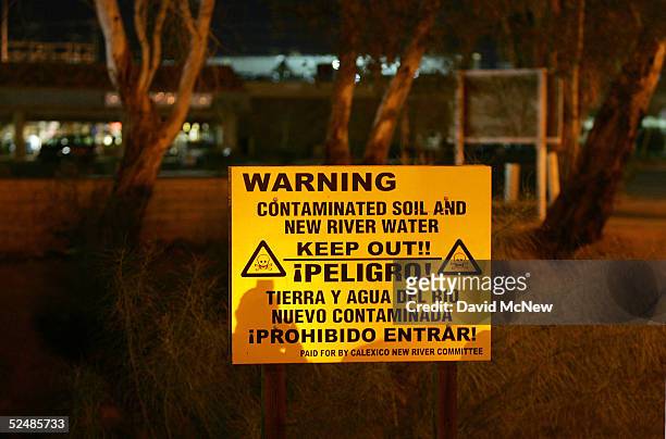 Sign warns of the danger of entering the New River, reportedly the most polluted river in the U.S. And down which some illegal immigrants float...