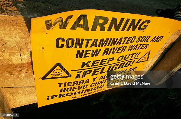 Sign warns of the danger of entering the New River, reportedly the most polluted river in the U.S. And down which some illegal immigrants float...