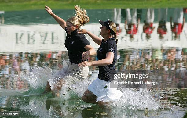 Annika Sorenstam of Sweden jumps into Champions Lake with her sister Charlotta Sorenstam after winning the LPGA Kraft Nabisco Championship 2005 at...