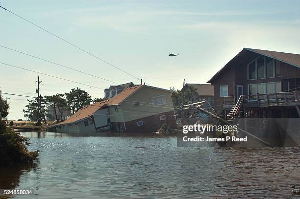 Military helicopter flies over the damage path of Hurricane Isabel. The category two hurricane produced major flooding and heavy damage when it hit...