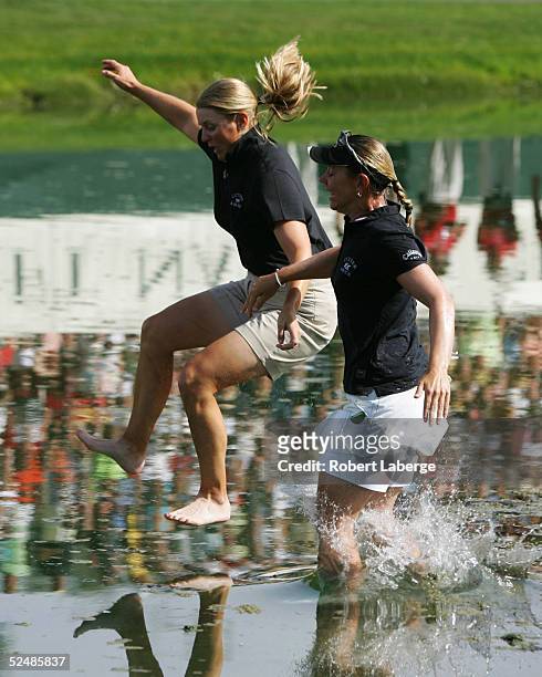Annika Sorenstam of Sweden jumps into Champions Lake with her sister Charlotta Sorenstam after winning the LPGA Kraft Nabisco Championship 2005 at...