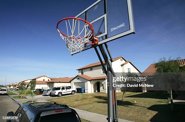 Basketball hoop lies curbside along a modern tract of homes in the city of El Centro on March 27, 2005 near Calexico, California. As security is...