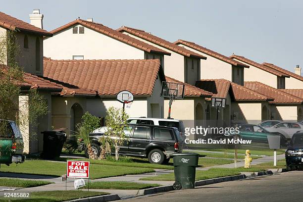 For Sale sign lies outside a home along a modern tract in the city of El Centro on March 27, 2005 near Calexico, California. As security is tightened...