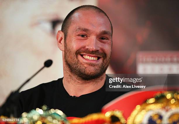 Reigning WBO, WBA and IBO heavyweight champion Tyson Fury smiles during Tyson Fury and Wladimir Klitschko head to head press conference at Manchester...