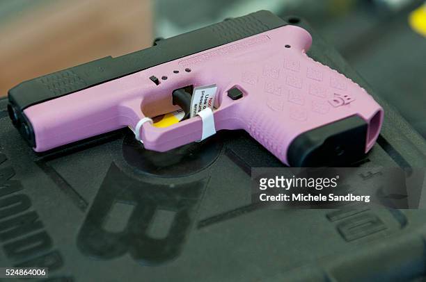 Pink handgun being sold at the store. 2013 April 18, Local Guan & Pawn Shop Sales Are Up And Inventory Is Down