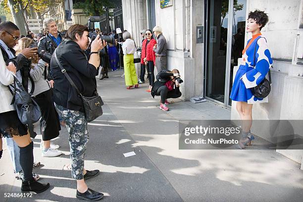 Invitees wait outside ahead of Chinese designer Masha Ma's show at the Monica Bismarck American Center on 4th October 2015. Outside less established...