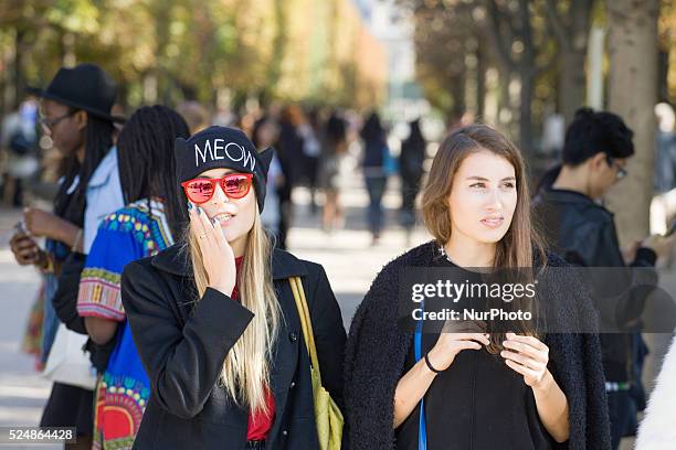 Models, photographers and fashion professionals are seen gathering outside the shows during Paris Fashion Week. Formal shows take place on the runway...