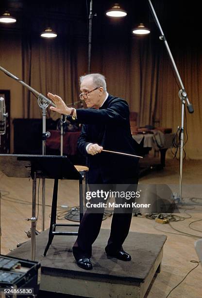 German conductor, pianist and composer Bruno Walter conducting an orchestra at a recording studio, 1950.