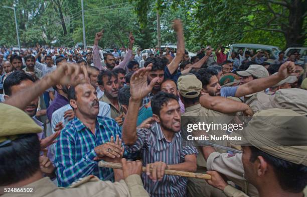 Indian police stop Kashmiri government employees as they shout slogans during a protest against the government on August 10, 2015 in Srinagar, the...