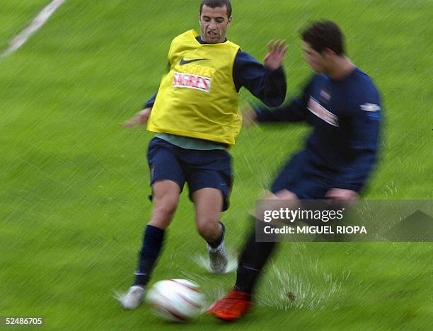 Portugal's player Simao Sabrosa tries to control the ball next to his teammate Cristiano Ronaldo during their training at the 1de Maio Stadium, in...