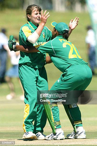 Johmari Logtenberg and Shafeeqa Pillay of South Africa celebrate the wicket of Belinda Clark during the Womens Cricket World Cup match between South...