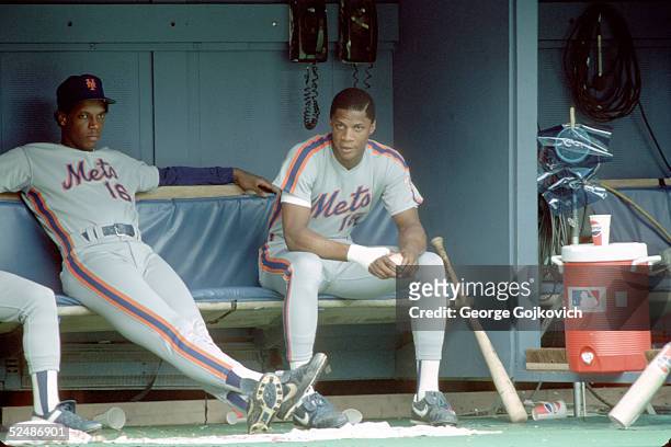 Pitcher Dwight Gooden and outfielder Darryl Strawberry of the New York Mets in the dugout during a game against the Pittsburgh Pirates at Three...