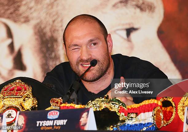 Reigning WBO, WBA and IBO heavyweight champion Tyson Fury winks during Tyson Fury and Wladimir Klitschko head to head press conference at Manchester...