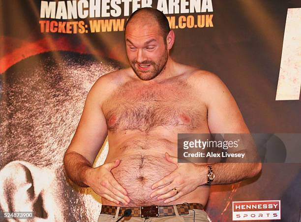 Bare chested WBO, WBA and IBO heavyweight champion Tyson Fury speaks after removing his shirt during Tyson Fury and Wladimir Klitschko head to head...