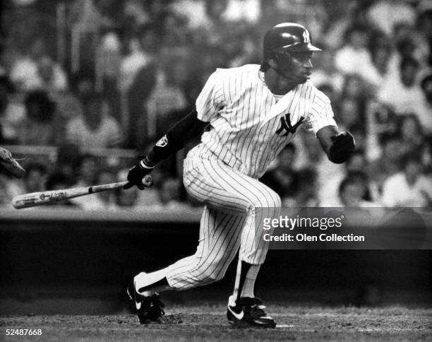 Outfielder Deion Sanders of the New York Yankees swings at the pitch during his first major league game against the Seattle Mariners on May 31, 1989...