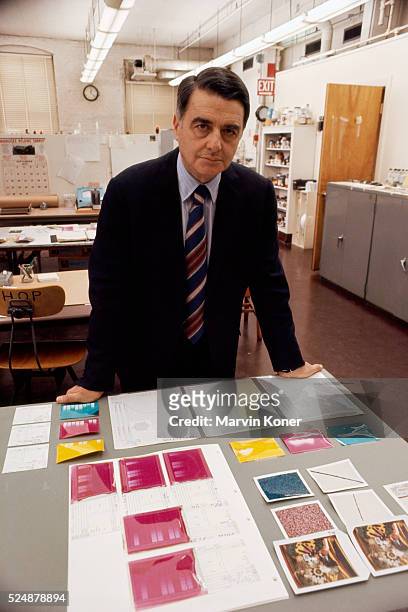 American scientist and inventor Edwin H Land , co-founder of the Polaroid Corporation, stands with Polaroid photographs and research results laid out...