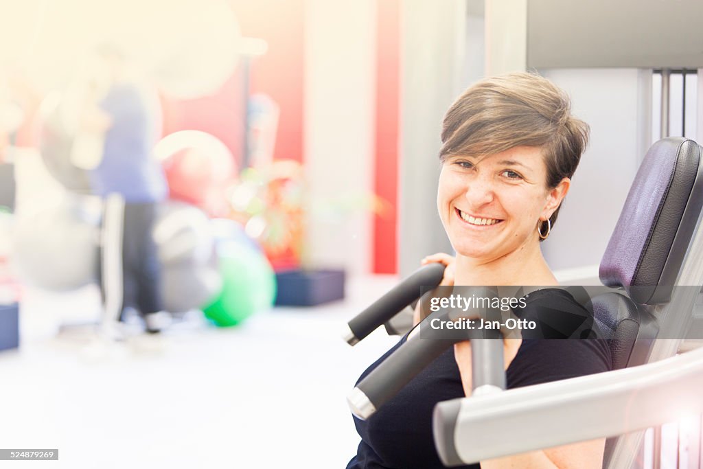 She smiles during a break in fitness studio