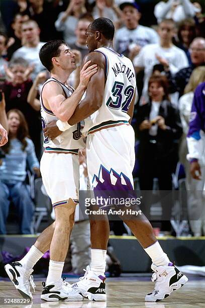 John Stockton and Karl Malone of the Utah Jazz talk about a play during an NBA game against the Detroit Pistons on March 7, 1997 at the Delta Center...