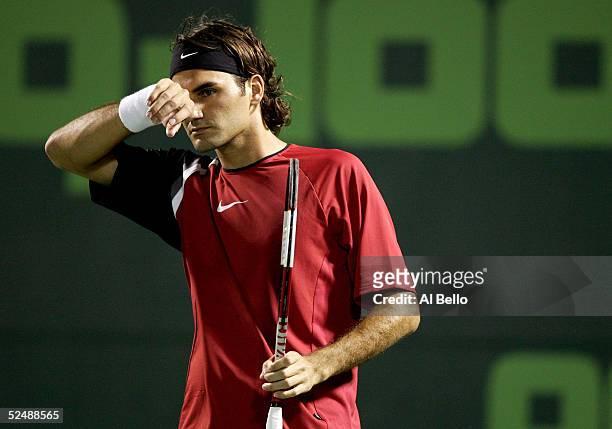 Roger Federer of Switzerland wipes his brow during his match against Mariano Zabaleta of Argentina during the NASDAQ-100 Open at the Crandon Park...