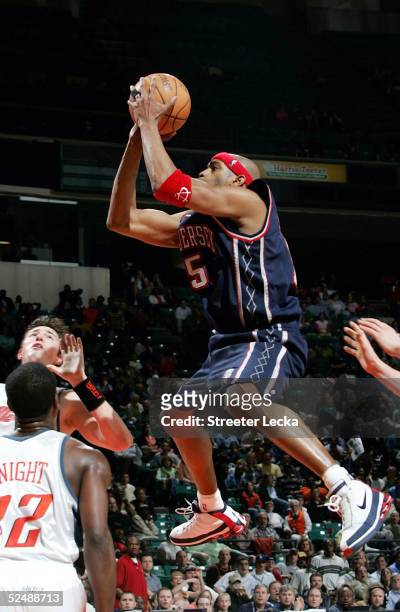 Vince Carter of the New Jersey Nets shoots the ball in NBA action against the Charlotte Bobcats March 28, 2005 at the Charlotte Coliseum in...