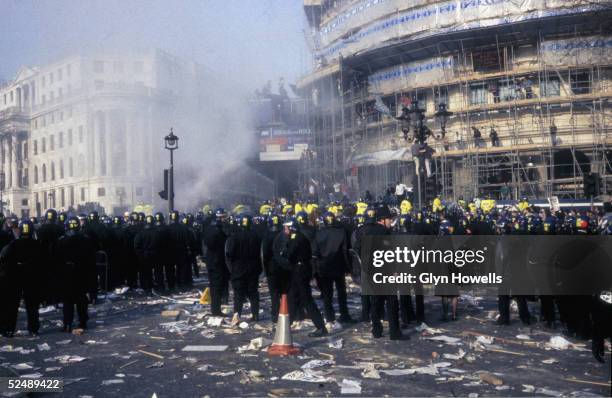 Large group of police officers in Trafalgar Square, London, during the Poll Tax riot, 31st March 1990.