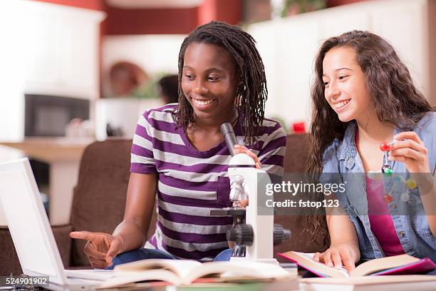 education.  teenage girls studying science at home. homework. - home base stockfoto's en -beelden