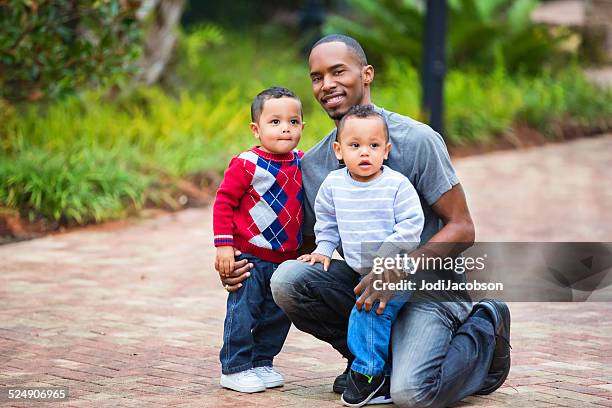 black single father with his two year old twin boys - twin boys stock pictures, royalty-free photos & images