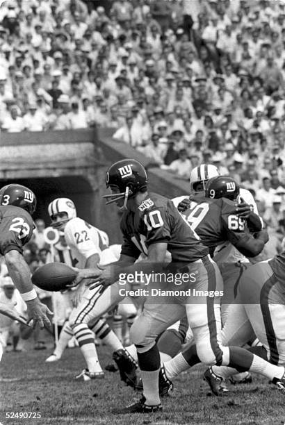 Quarterback Fran Tarkenton of the New York Giants, hands the ball during a preseason game in 1969 against the New York Jets.