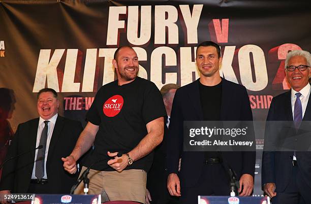 Tyson Fury dances next to Wladimir Klitschko as they go head to head during a press conference at the Manchester Arena on April 27, 2016 in...