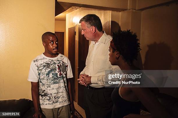 Public Advocate BILL DE BLASIO and his daughter CHIARA DE BLASIO speak to Lincoln Houses resident REGINALD WILSON at mayoral sleepover. Photo: Kevin...