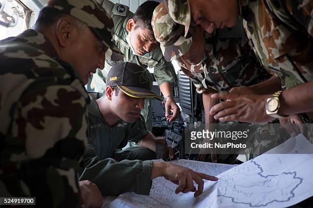 May 6, 2015--Indian Air Force helicopter officials map out their route before an aid delivery mission where they planned to also pick up injured...