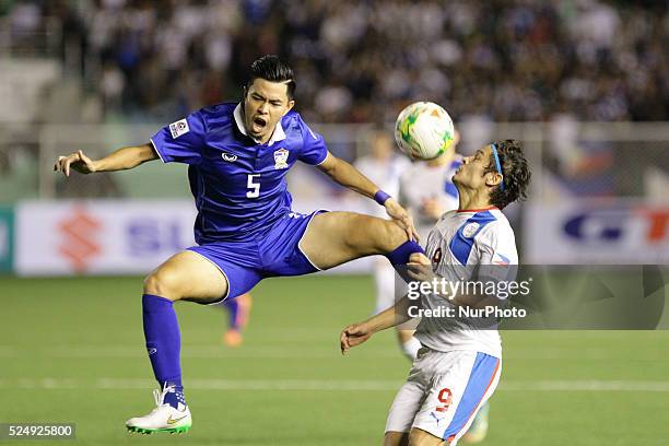 Manila, Philippines - Thailand's Suttinun Phukhom is challenged by Misagh Bahadoran of the Philippines on the first leg of the AFF semi-finals in...