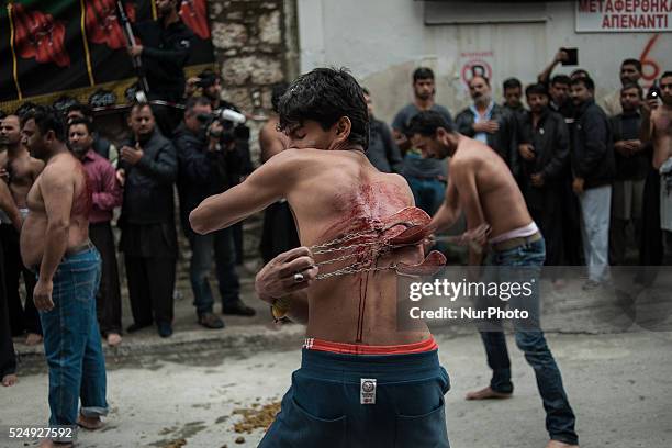 Members of the Shiite community take part in a ceremony to mark Ashura, the holiest day on the Shiite calendar, in Piraeus, Greece, Saturday 24...
