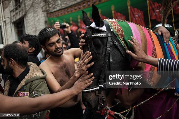 Members of the Shiite community take part in a ceremony to mark Ashura, the holiest day on the Shiite calendar, in Piraeus, Greece, Saturday 24...